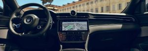 The steering wheel, dashboard, and central console of the 2025 Maserati Grecale. Outside the windshield is a view of the Prince Eugene Monument in Vienna.